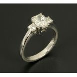 An 18 ct white gold ring, set with a radiant cut diamond to centre and diamonds to each shoulder,