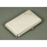 A silver cigarette case, with double hinged lid, Birmingham 1918.  Length closed 13.5 cm.