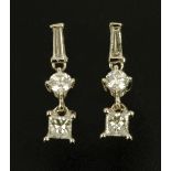 A pair of 18 ct white gold dropper earrings, set with princess, baguette and brilliant cut diamonds,