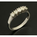 An 18 ct white gold five stone ring, set with diamonds weighing .52 carats, size N/O.