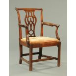 A George III mahogany carver armchair, with yoke shaped top rail, pierced splat back, outswept arms,