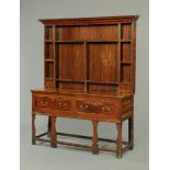 A George III oak Shropshire dresser base, with associated Delft rack above,