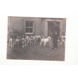 Hunt photograph of early Melbreak Foxhounds with huntsman and hounds outside a house.