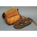 Tan leather cartridge bag and two cartridge belts.