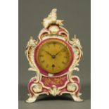 A French porcelain mantle clock, with scrolling Rococo frame, gilt dial, single-train movement.
