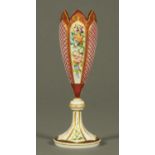 A 19th century Bohemian glass vase, milk glass overlay to cranberry,