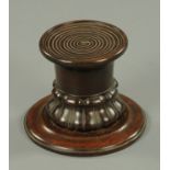 A Victorian mahogany pedestal, with ring turned top and carved base.  Diameter 17.5 cm.
