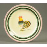 A Quimper plate, decorated to the centre with a cockerel.  Diameter 25 cm.