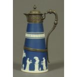A Wedgwood Blue Jasperware claret jug, with pewter mounts.  Height 28 cm.