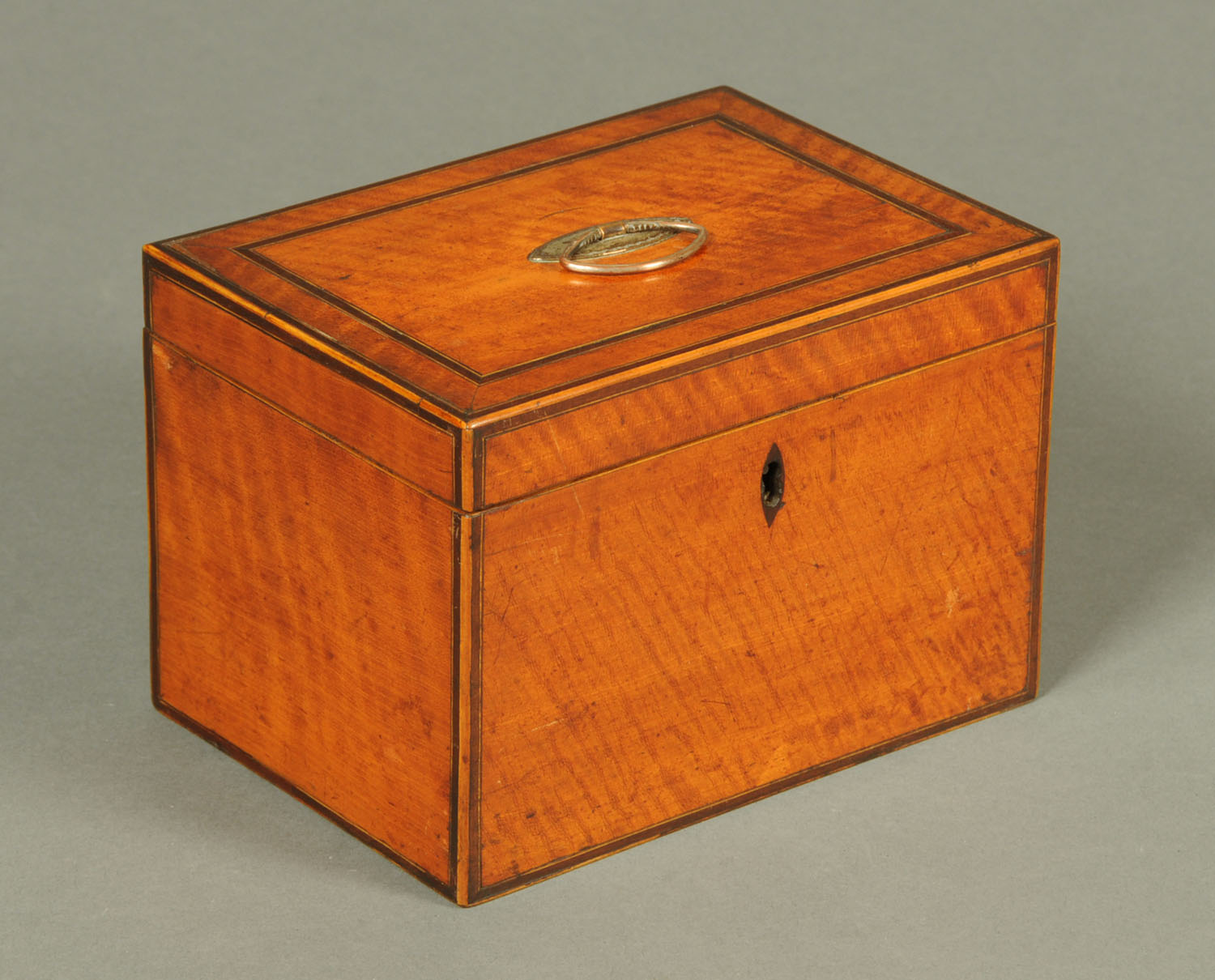 A George III satinwood tea caddy, boxwood and ebony strung,