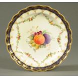 A Royal Worcester shallow dish, painted with fruit to the centre and signed "Phillips",