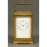 An Edwardian brass carriage clock, timepiece only, Roman numerals.  Height excluding carrying handle