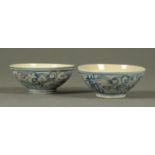 A pair of Chinese blue and white pottery bowls, with swirl decoration.  Diameter 11 cm.