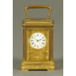 An Edwardian French brass miniature carriage clock, with chased dial.  Height excluding carrying