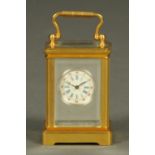 A miniature brass carriage clock,