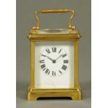 An Edwardian brass carriage clock, with Roman numerals also inscribed "Made in France".