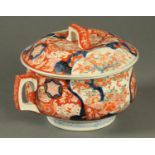 A 19th century Imari chamber pot, lidded.  Diameter 23 cm.