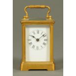 An Edwardian brass carriage clock, with Roman numerals and rounded corners to the case.