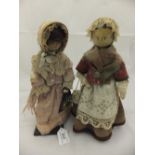 Two 18th Century painted wooden dolls; one dressed in jacket and shawl, with lace mop cap and