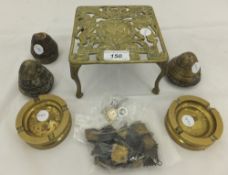 Three World War II brass nose cones, a pair of World War II trench art ashtrays, and a military