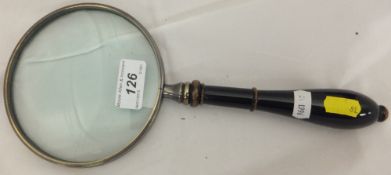 A magnifying glass with a turned wooden