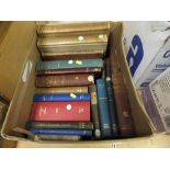 A box containing various books on the su