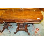 An early Victorian rosewood tea table, the fold-over top on a square baluster and waisted pedestal