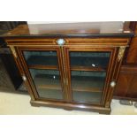 A Victorian rosewood and inlaid two door display cabinet raised on a bracket foot base CONDITION