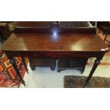 A Victorian mahogany console table with shallow raised back on turned and ringed tapering legs