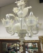 A five branch glass Venetian style ceiling light fitting decorated with flowers and leaves, the