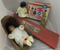 A boxed Herald Series of model soldiers, a canework dolls' crib, three various dolls and a boxed
