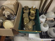 A box containing assorted brass oil lamp