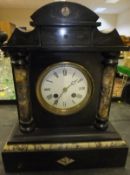 A black slate mantel clock with Roman nu