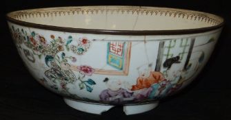 An 18th Century Chinese porcelain famille-rose fruit bowl decorated with figures in a garden setting