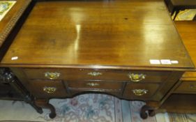 A late 18th Century oak lowboy, the plain top with moulded edge above one long and three short