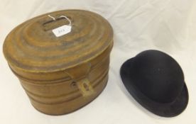A tin hat box containing a "Triple Crown