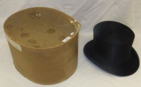 A black silk top hat by Davis Limited, initialled inside "AG", housed in a cardboard hat box