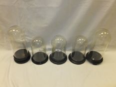 A collection of four glass domes, each r