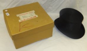 A black silk top hat by Moss Bros CONDITION REPORTS Overall with wear and scuffs.  Cardboard box