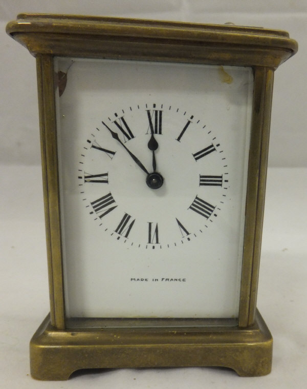 A brass carriage clock with Roman numera