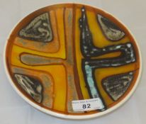 A Poole pottery shallow dish decorated i