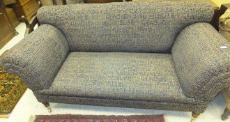 A modern upholstered scroll arm sofa in