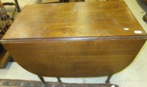 An oak drop-leaf gate-leg D end dining t