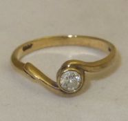A 9 carat gold and diamond set solitaire