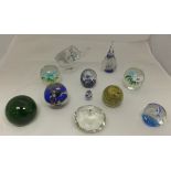 Eleven assorted glass paperweights to in