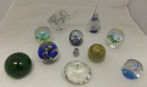 Eleven assorted glass paperweights to in