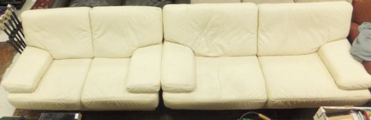 A cream leather three seat sofa, togethe