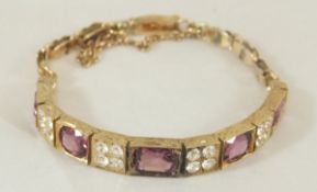 An un-marked gold bracelet with white an