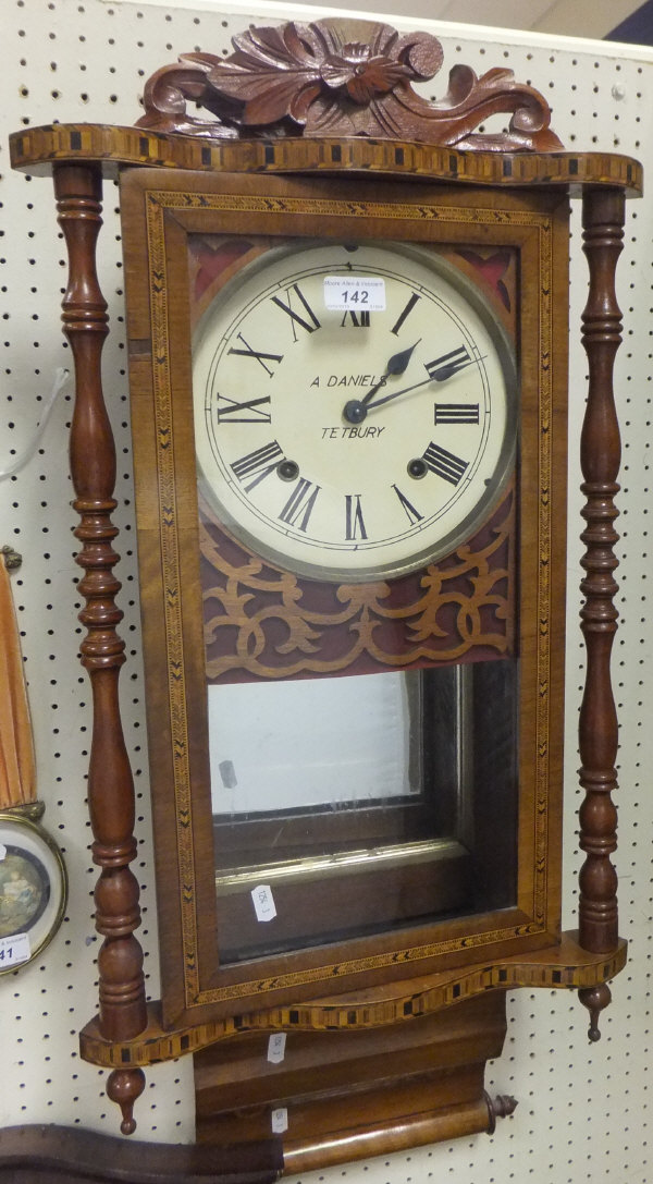 An A. Daniels of Tetbury mahogany framed pendulum wall clock with Roman numerals to the dial