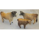 A Beswick pottery bull "Champion Dunsley Coy Boy", a Beswick pottery cow "Newton Tinkle" and a small